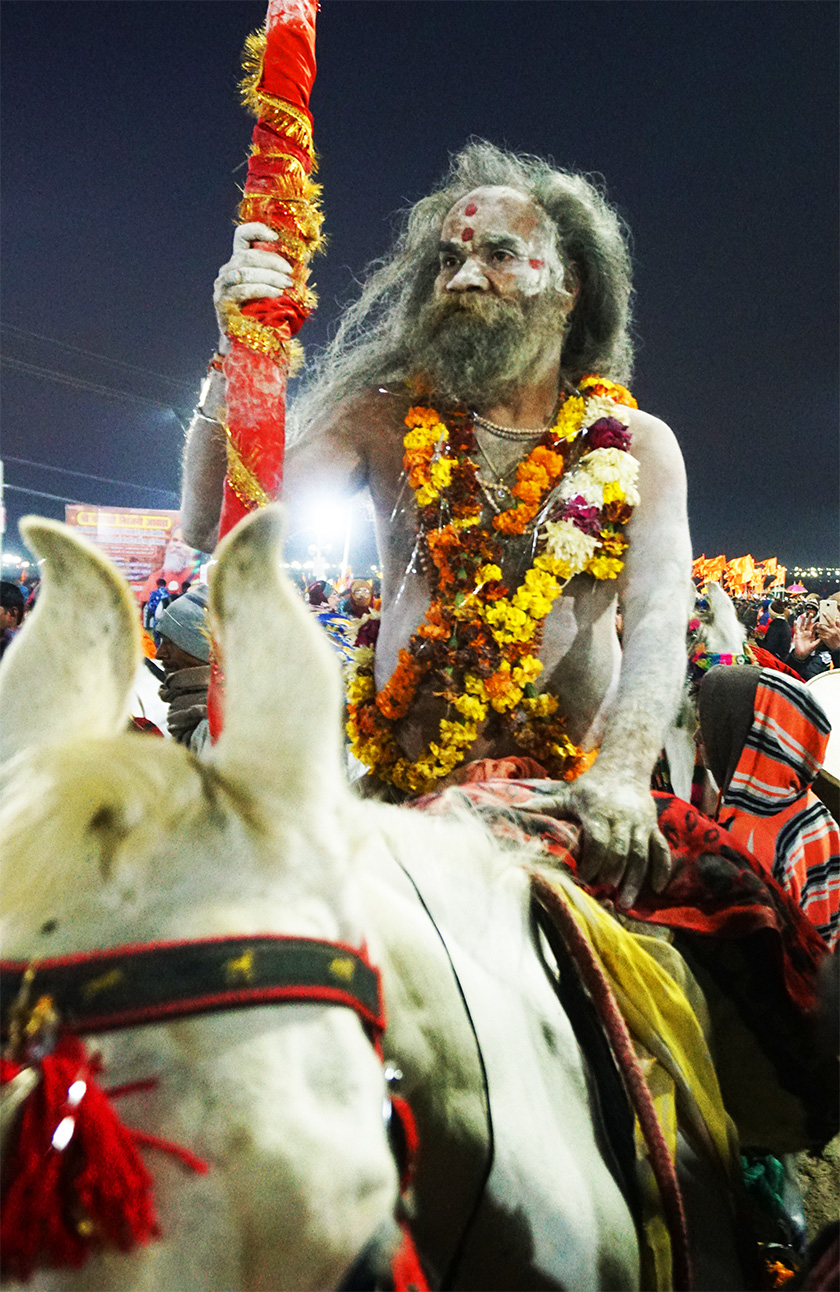 A naga baba riding a horse in Kumbh Mela 2019.