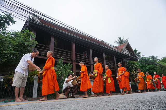 monks accept alms laos