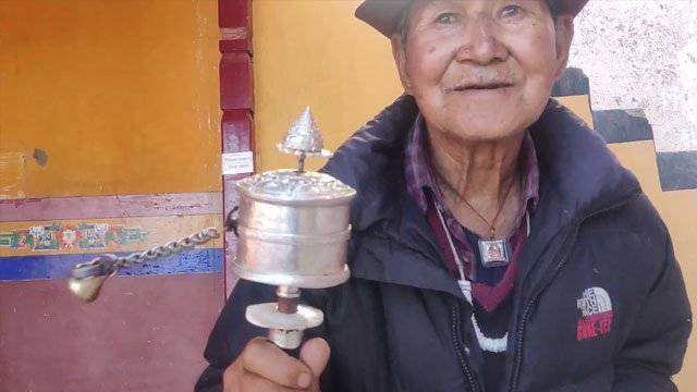 buddhist monk prayer wheel